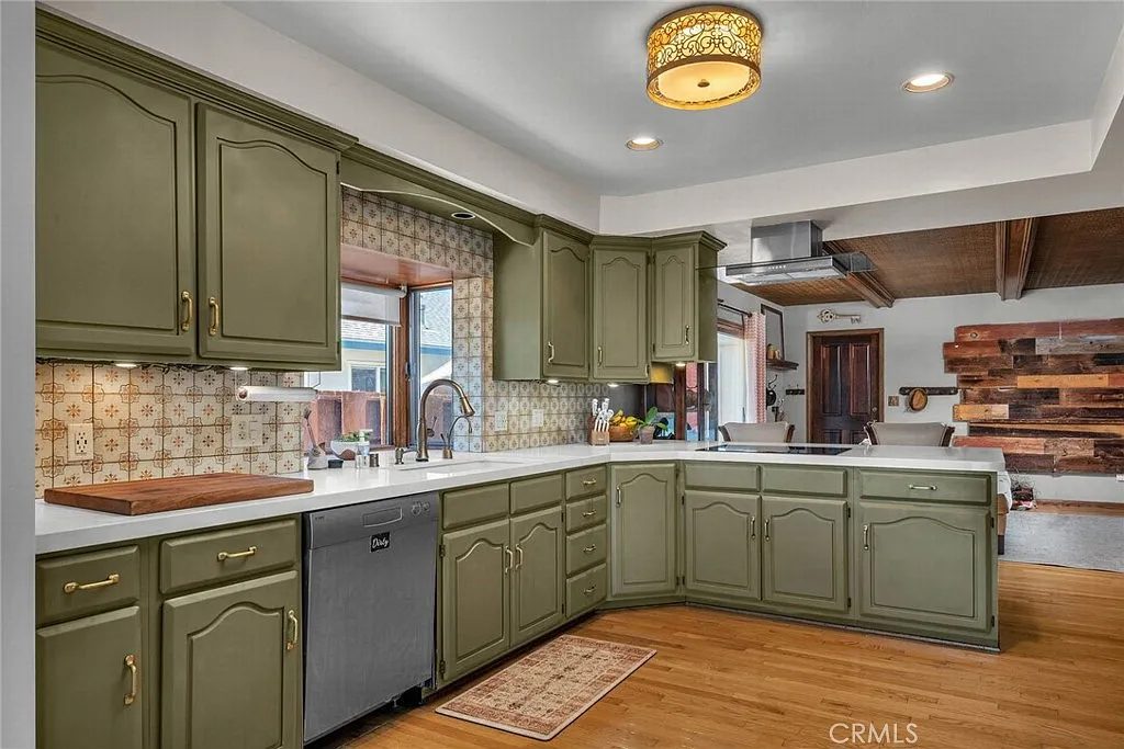 Kitchen with sage green cabinetry and full appliance suite at Eaglehaven, Rancho Palos Verdes
