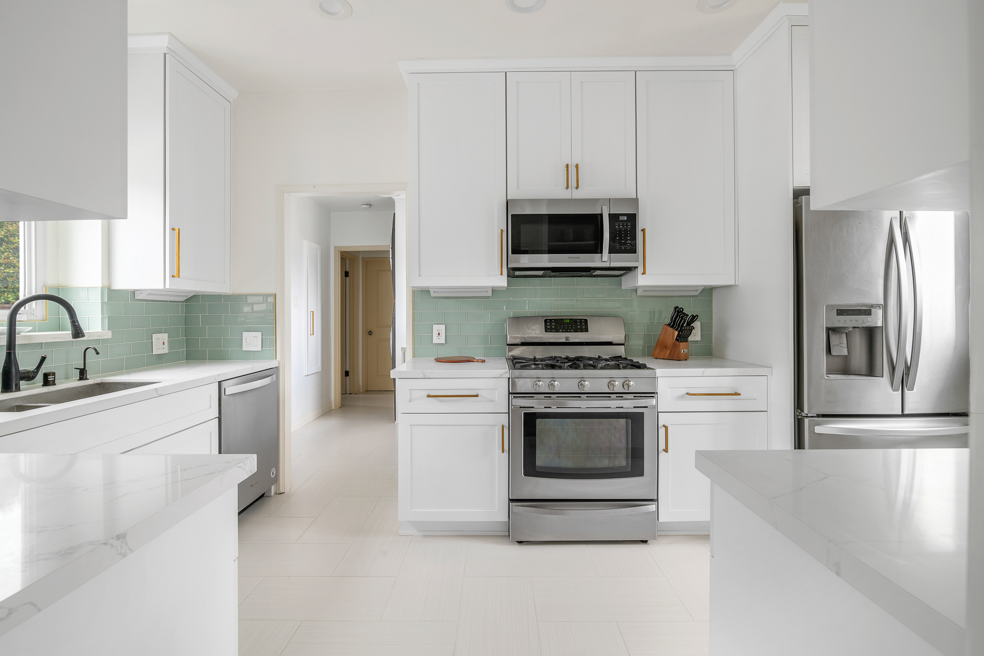 Designer kitchen with green tile backsplash at Casa de LA, a luxury furnished property managed by Earendel