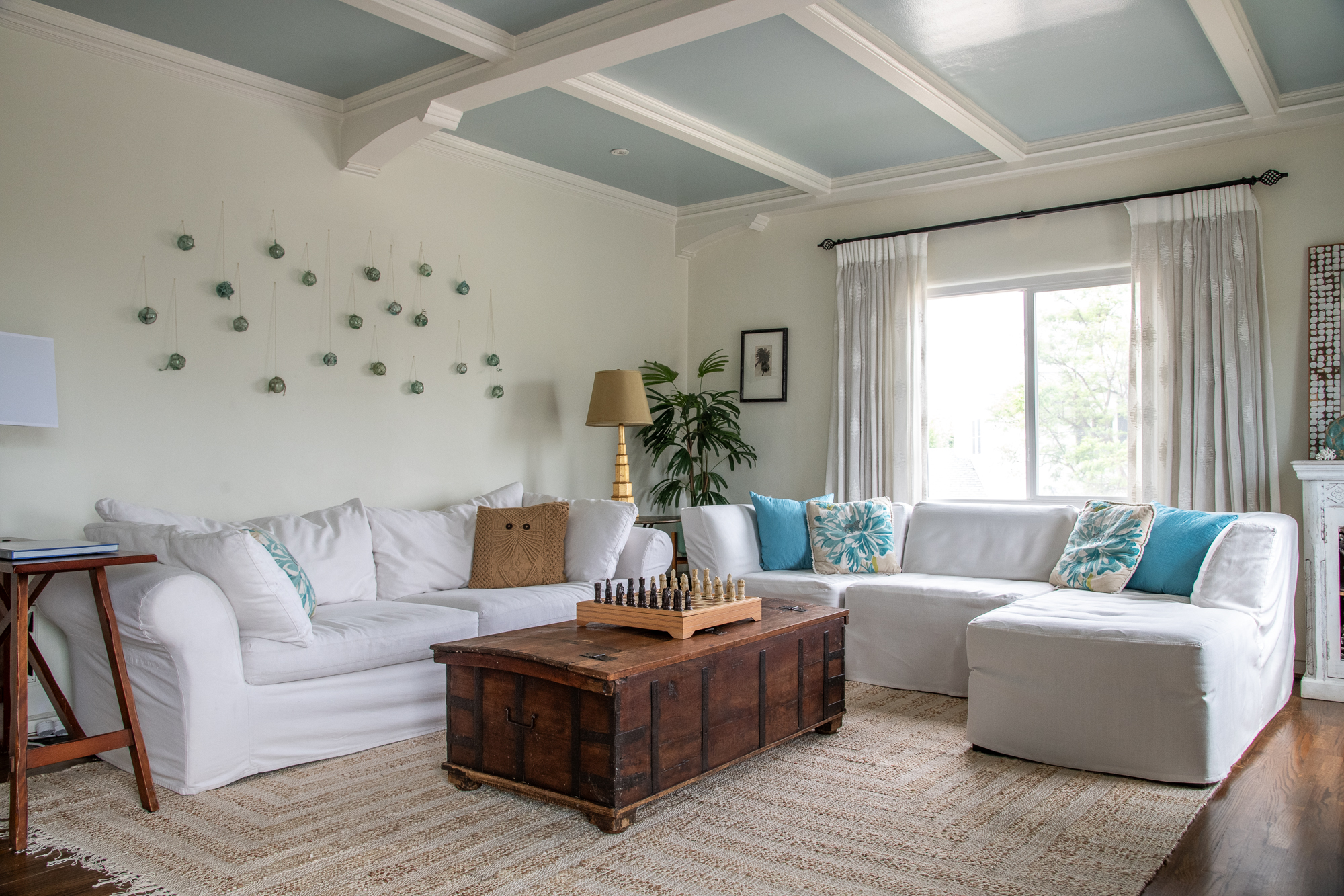 Grand living room with coffered ceiling at Casa de LA, a luxury furnished property in the Earendel portfolio