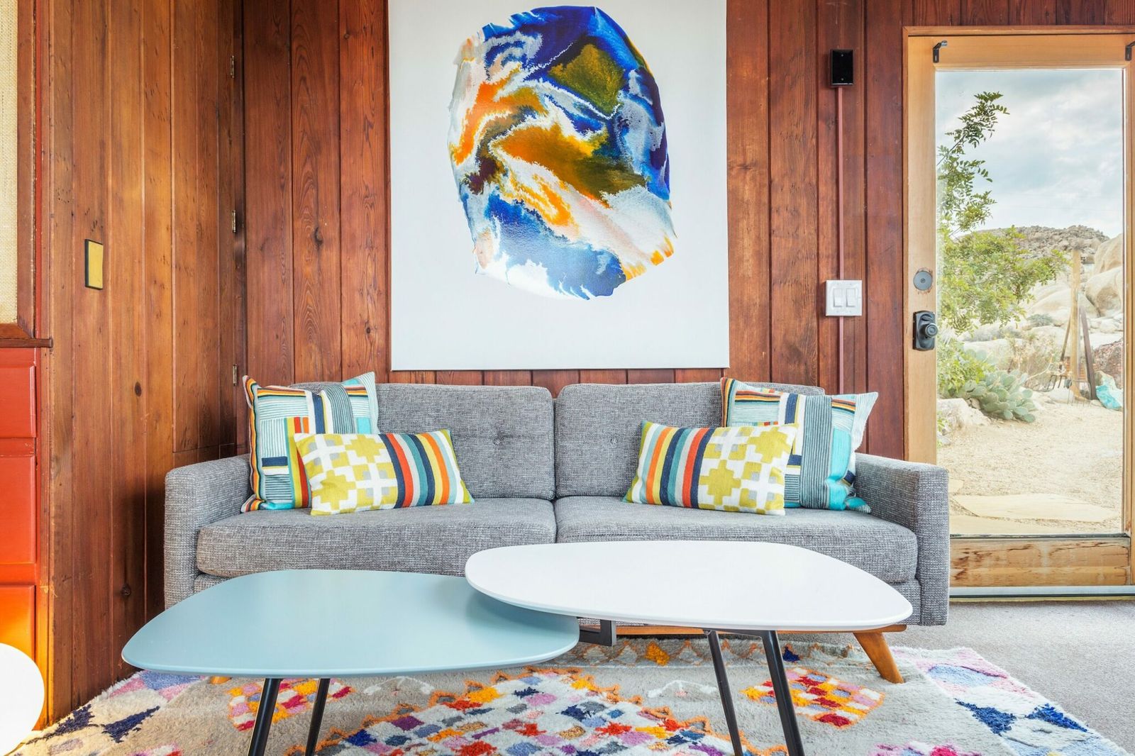Wood-paneled sitting room with contemporary art at Rockbound Oasis, the founder's first design property