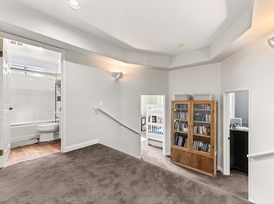 Open-plan living and dining room at Quail Drive, Mount Washington with hardwood floors and working fireplace