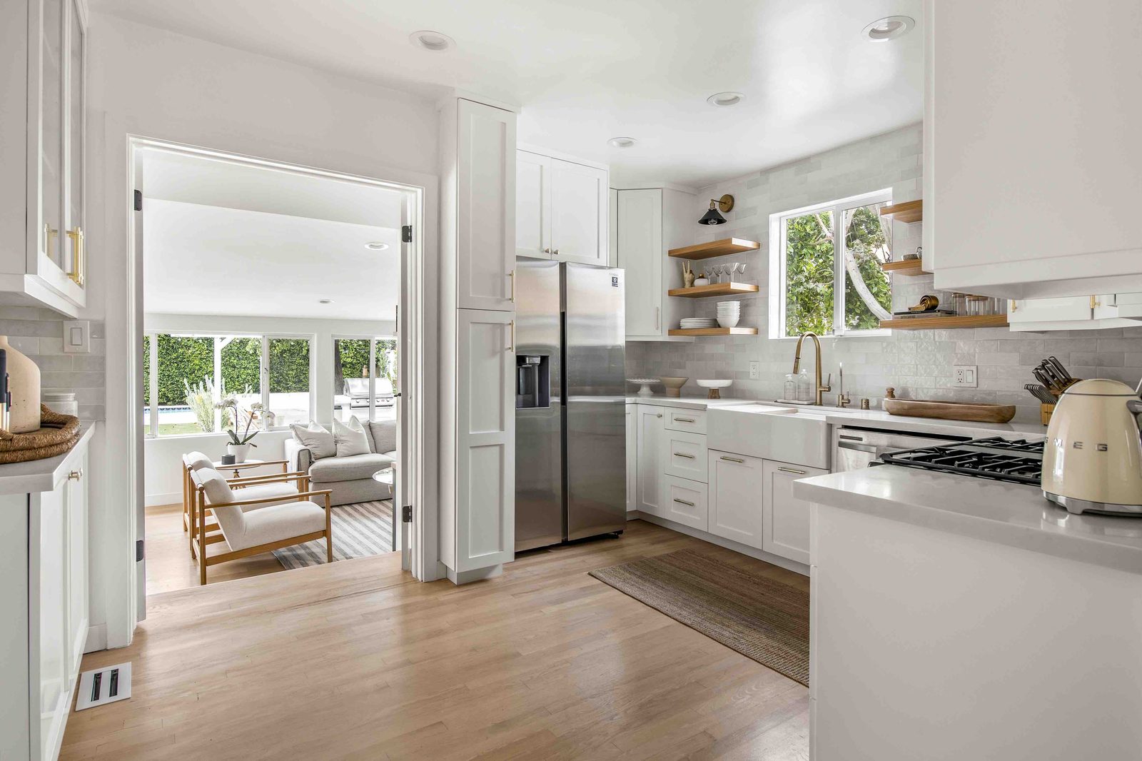 White farmhouse kitchen with stainless appliances at Rose House, Magnolia Park, Burbank